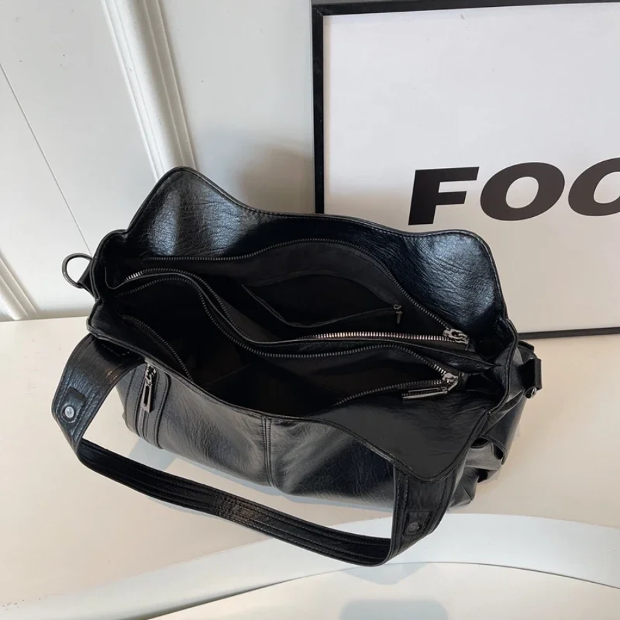 Midnight black leather shoulder bag, interior with zip compartment
