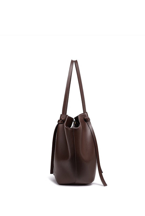 Dark brown leather tote bag, side view on white background