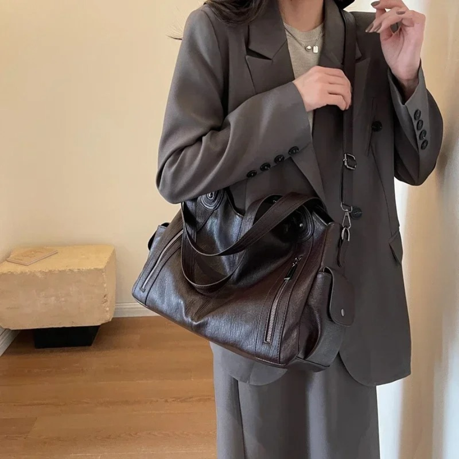 Espresso brown leather shoulder bag worn crossbody on model