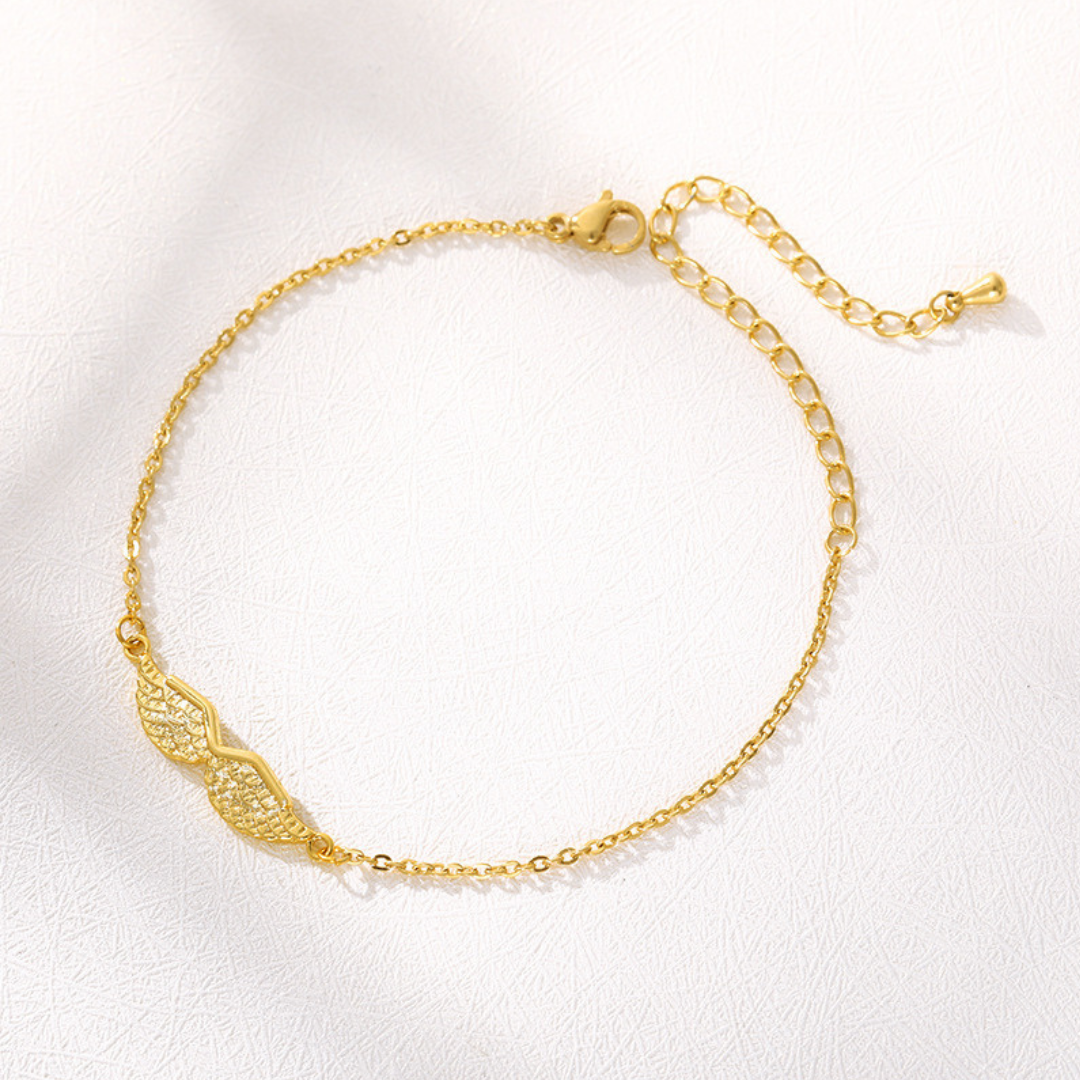Gold angel wing bracelet, flat lay close-up
