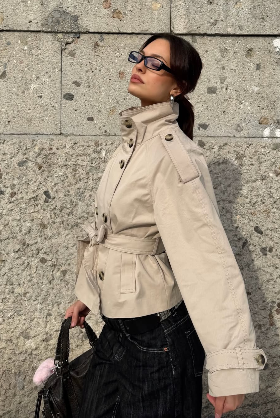 Sand short trench coat with high collar and belt, side view on model