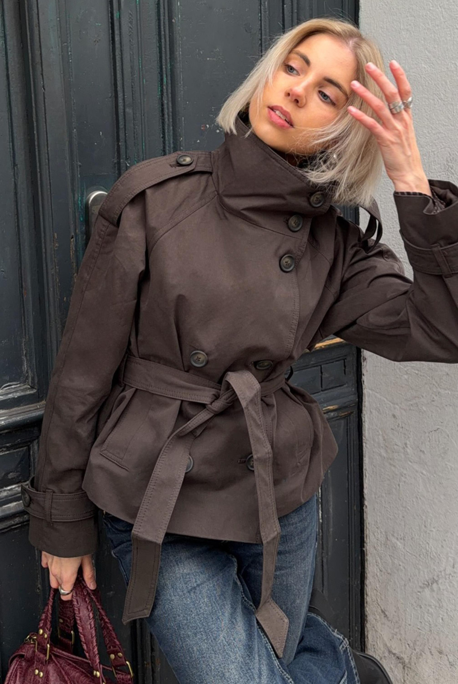 Brown short trench coat with belted waist, front view on model