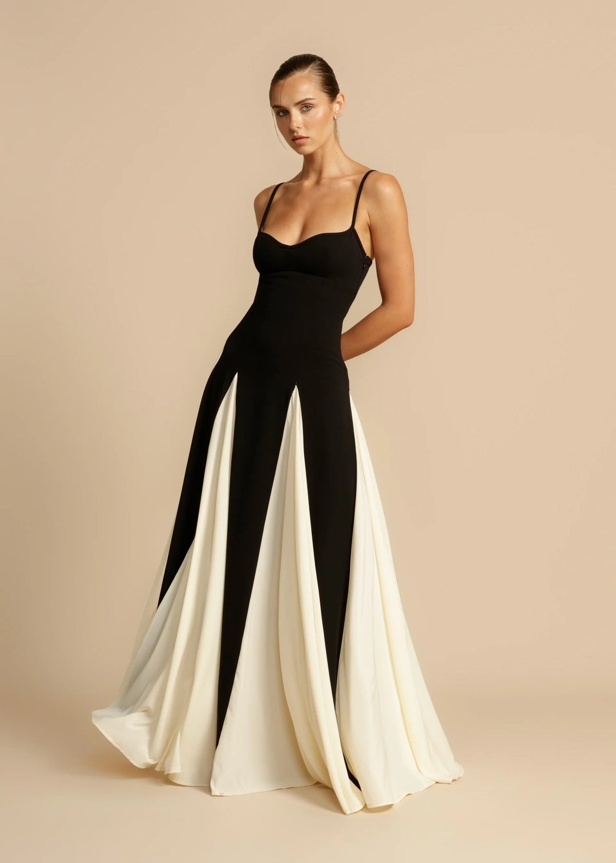 Black maxi dress with ivory godets, side angle on model