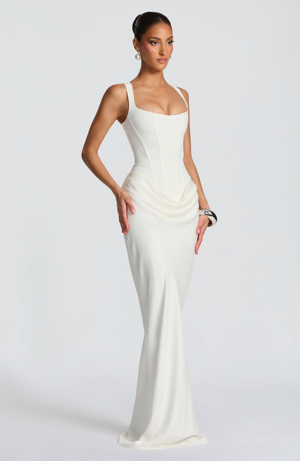 Ivory corset-style maxi dress on model, side view
