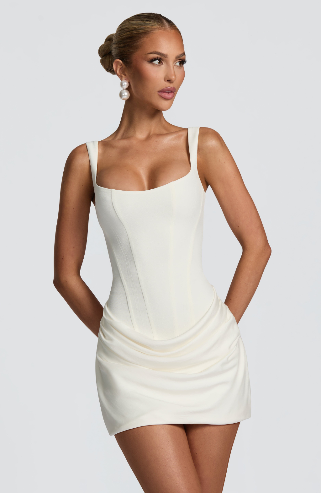 Ivory corset mini dress with ruched skirt, front view on model