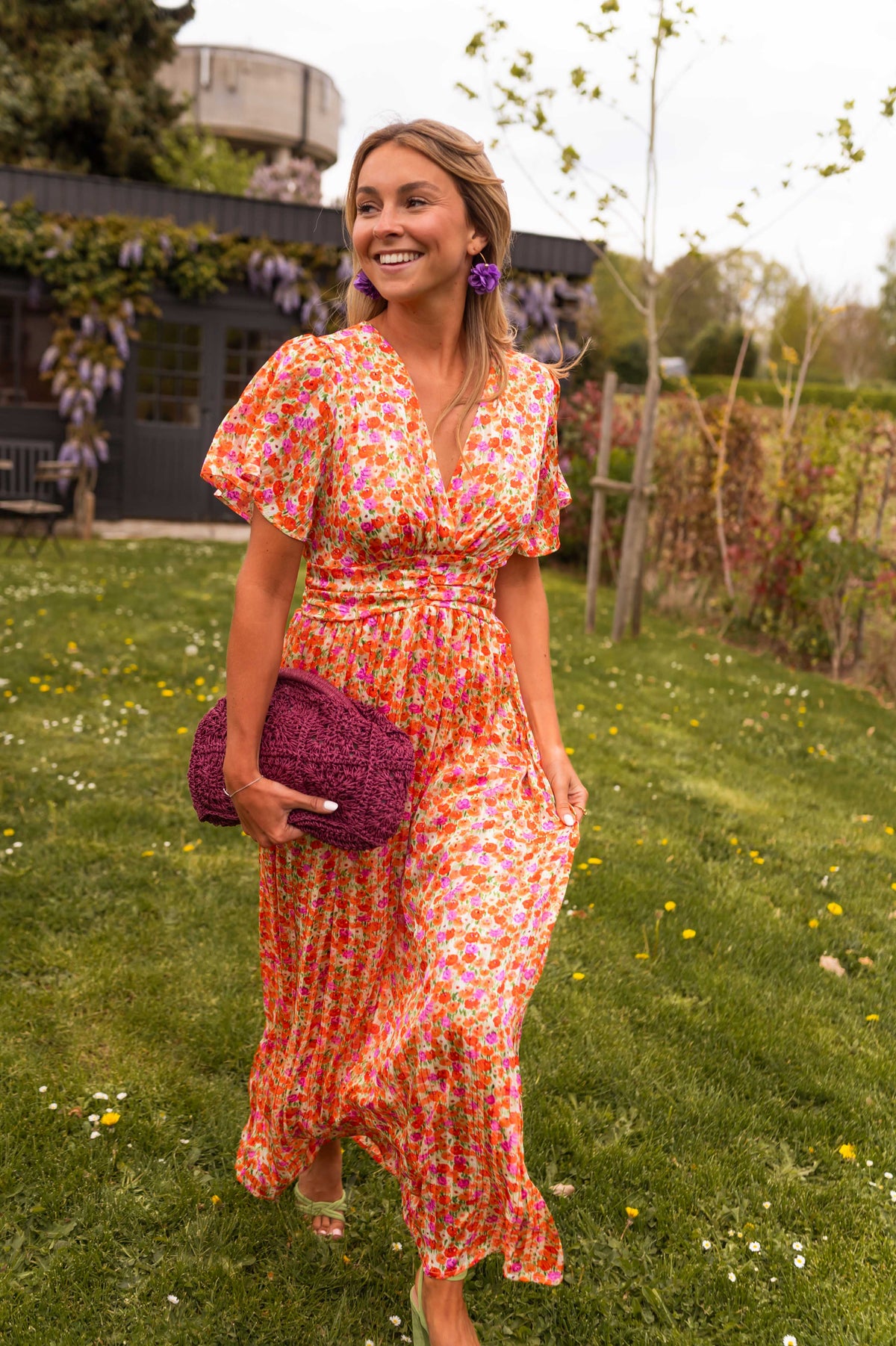 Orange floral print maxi dress, walking front view smiling