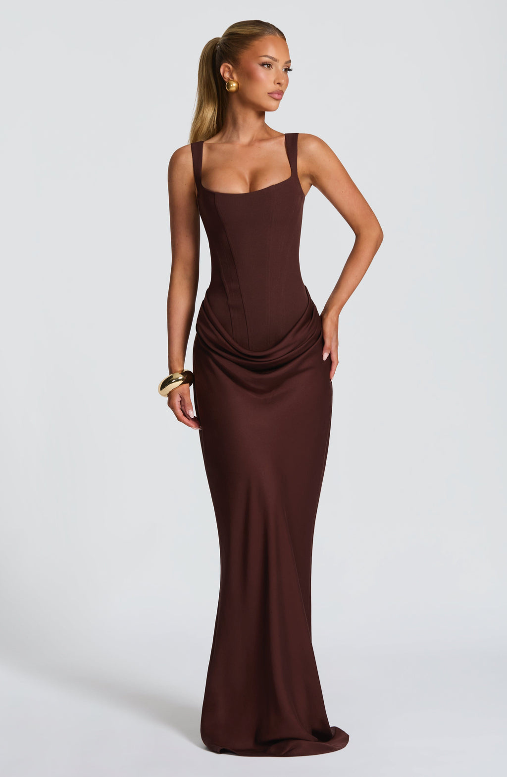 Mocha corset-style maxi dress on model, hand on hip pose