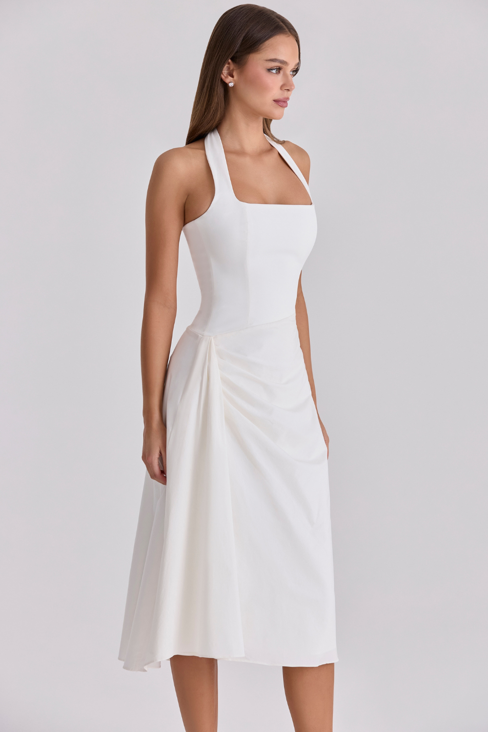 Ivory halter-neck midi dress, three-quarter side view on model