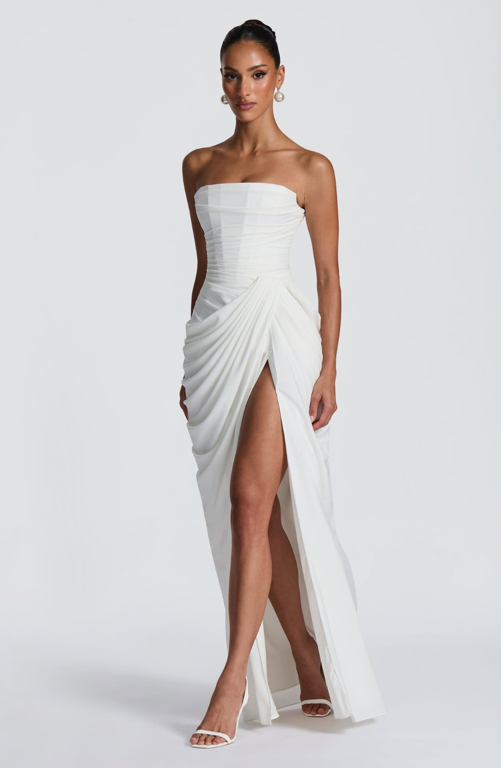 Ivory strapless maxi dress with thigh-high split, side view on model