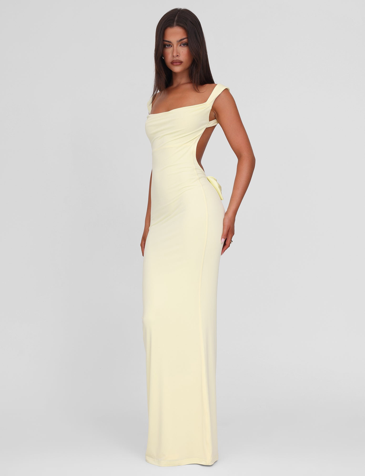Lemon yellow maxi dress with side bow cutout, side view on model