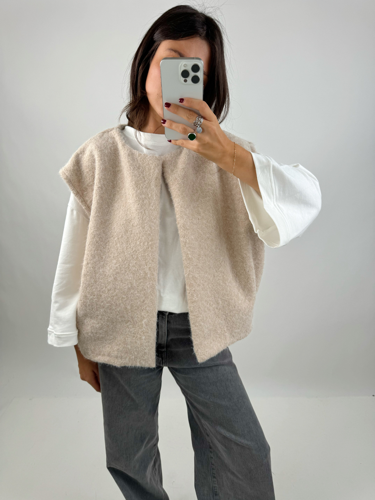 Beige bouclé knit vest with jeans, full mirror selfie on model