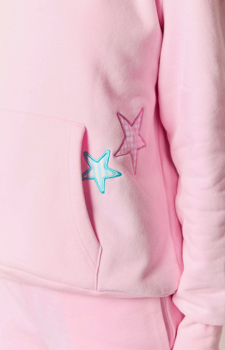 Close-up of pink hoodie pocket with gingham star patches