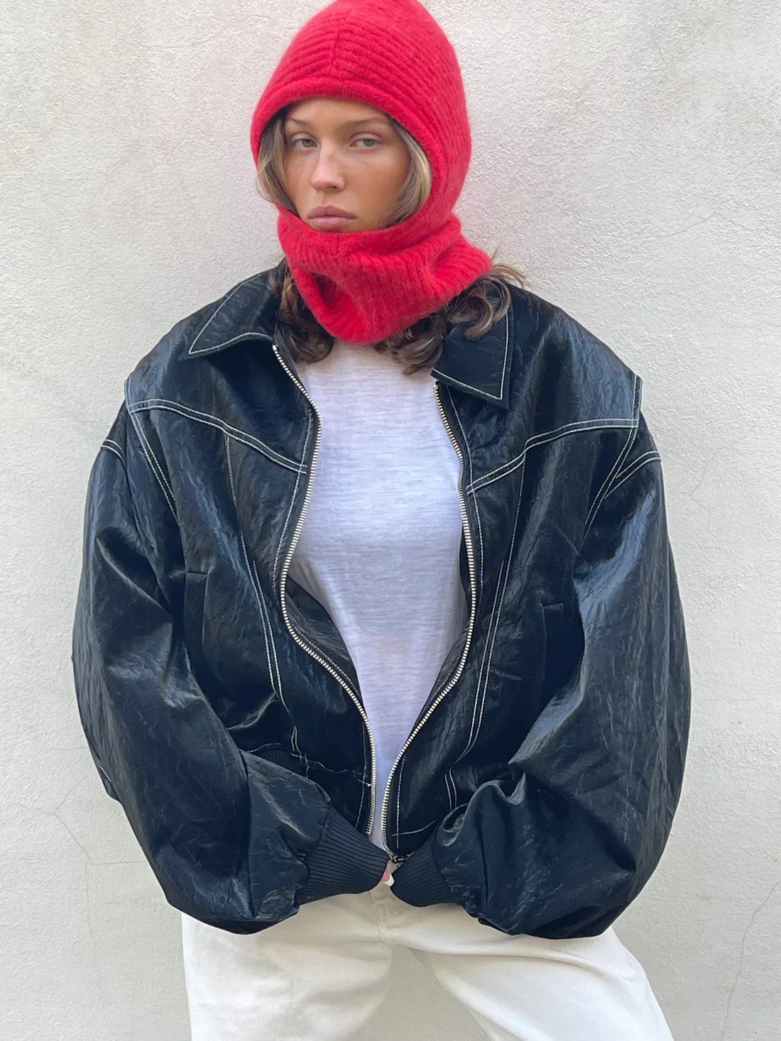 Black oversized contrast-stitch jacket with red knit balaclava, front view