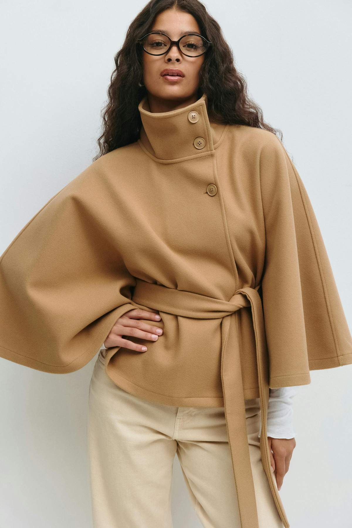 Beige belted cape jacket, close-up front view on model