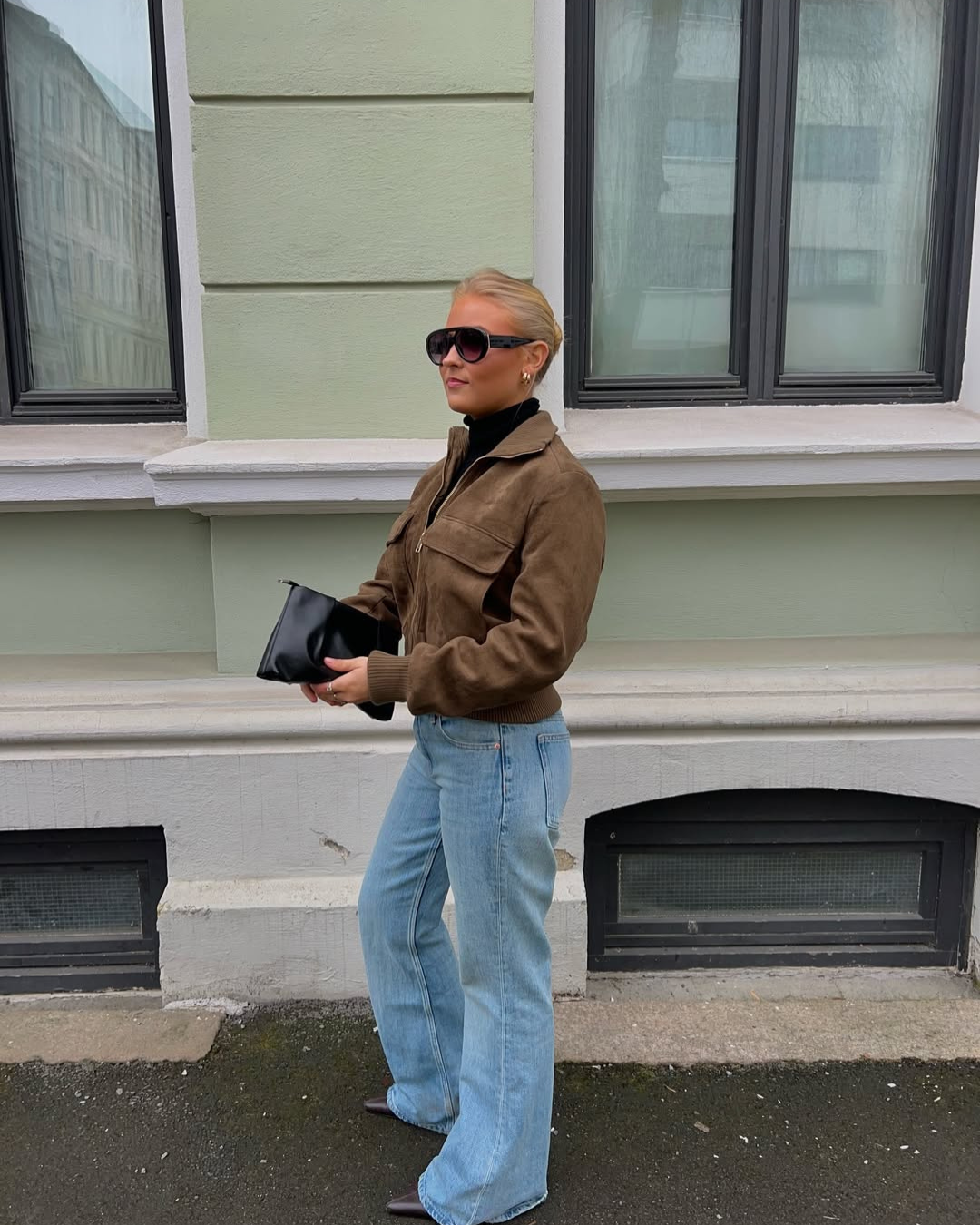 Brown suede bomber jacket, model looking over shoulder, side view