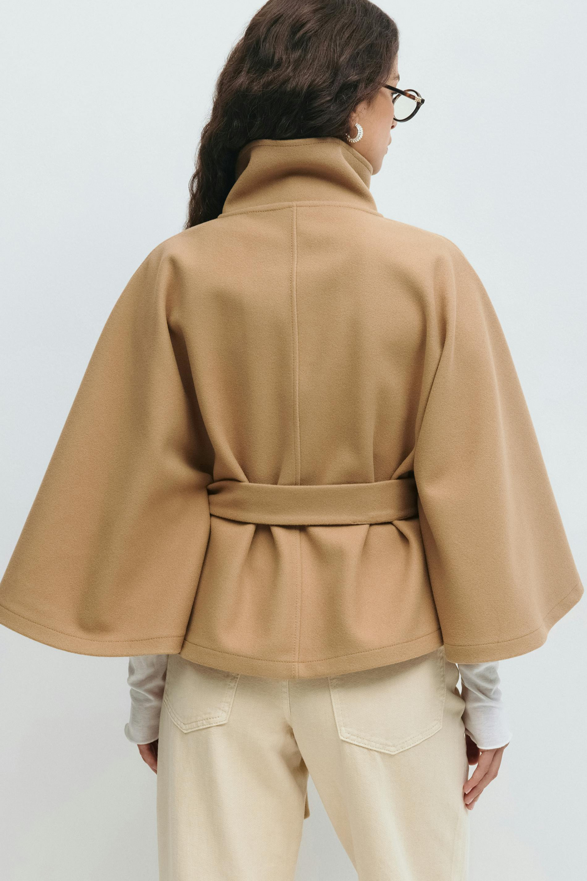 Beige belted cape jacket, back view on model