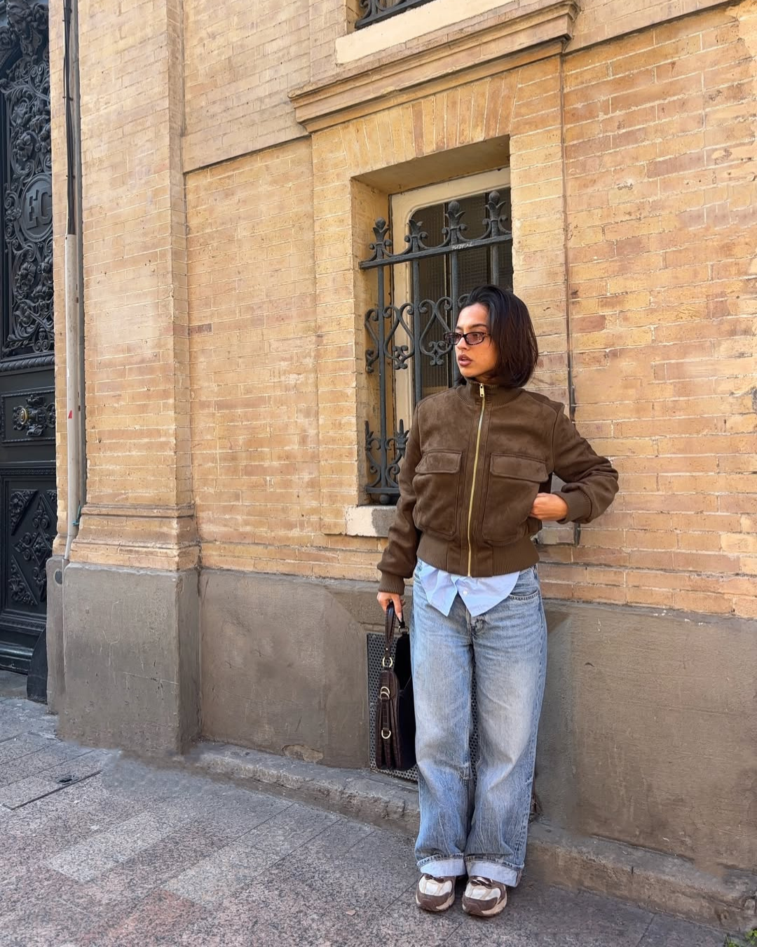 Brown suede bomber jacket, full length front view on model