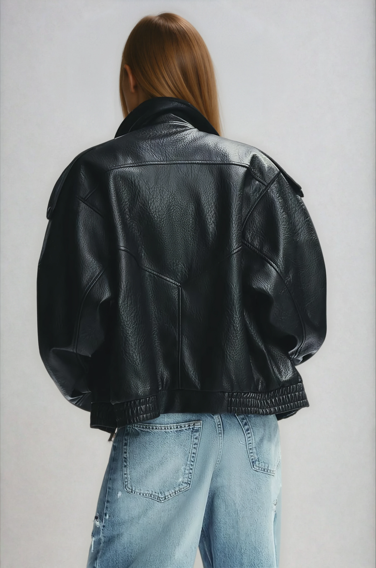 Black oversized leather jacket on model, back view