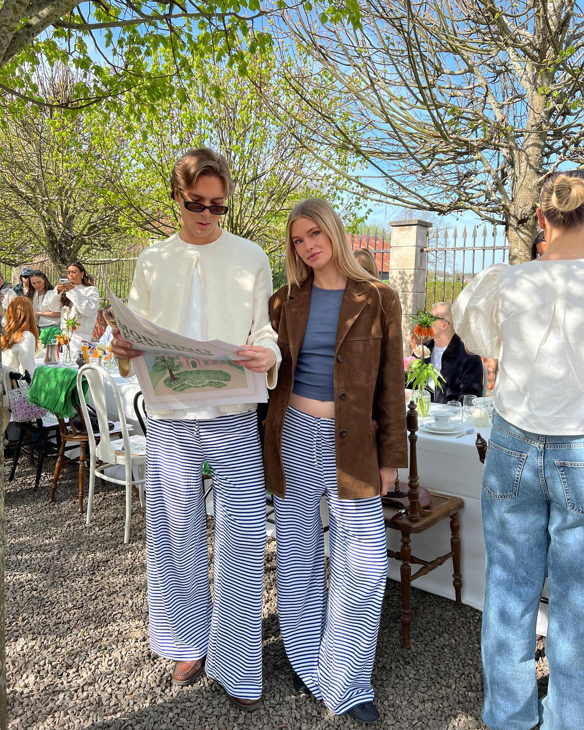 Navy and white striped wide-leg trousers, outdoor event lifestyle shot