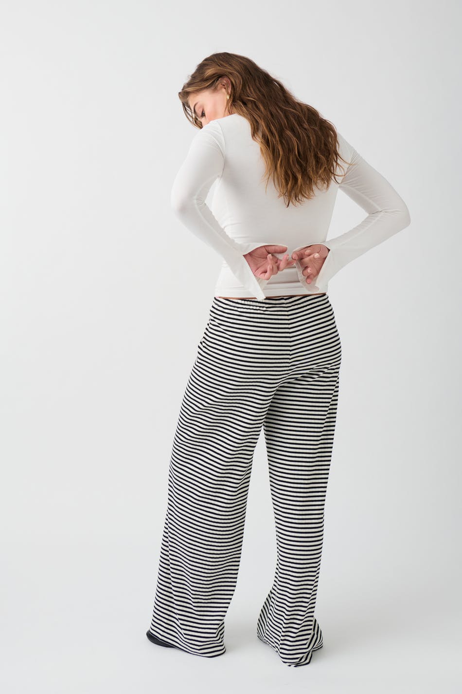 Black and white striped wide-leg trousers, back view on model