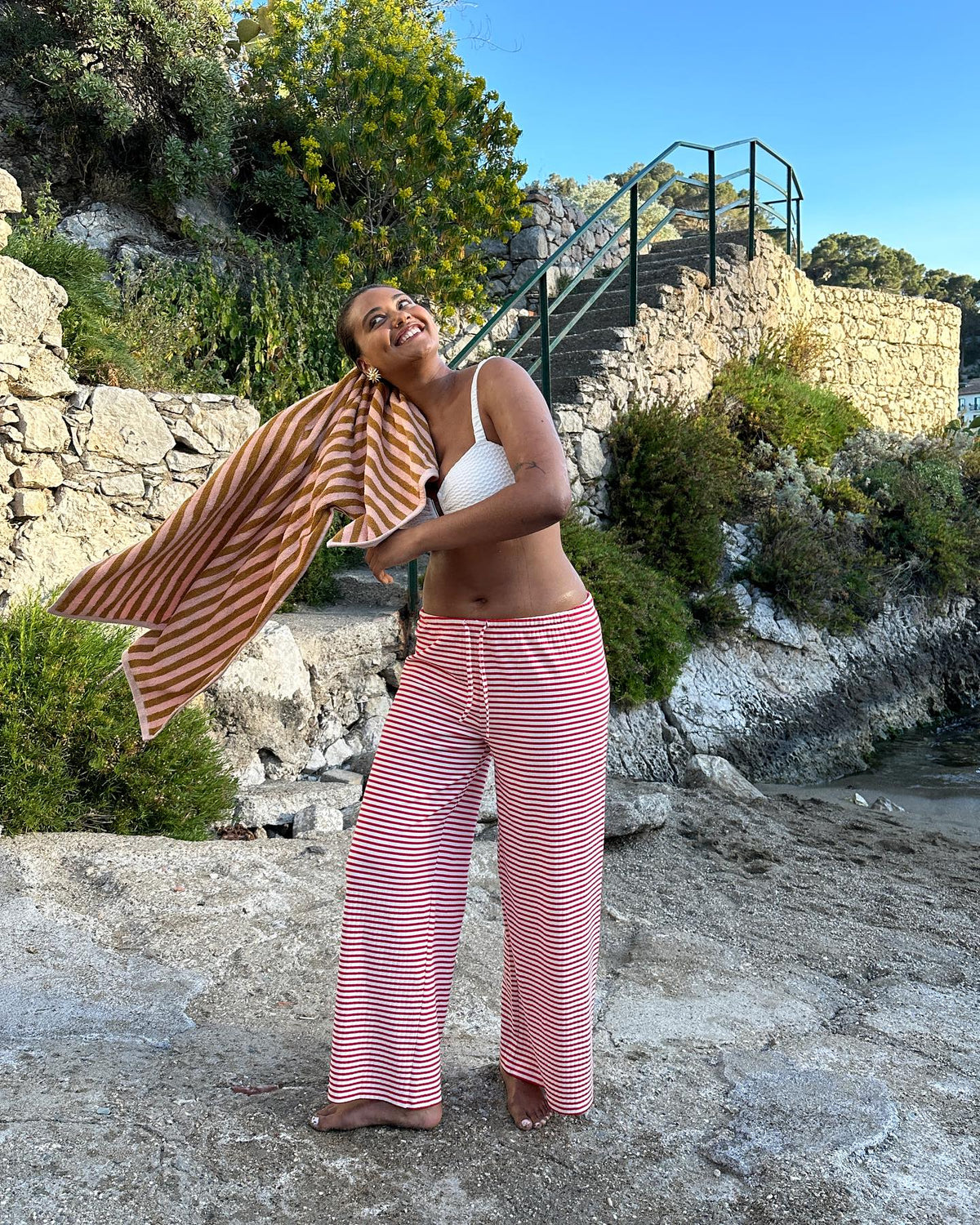 Red and white striped wide-leg trousers, beach lifestyle shot on model