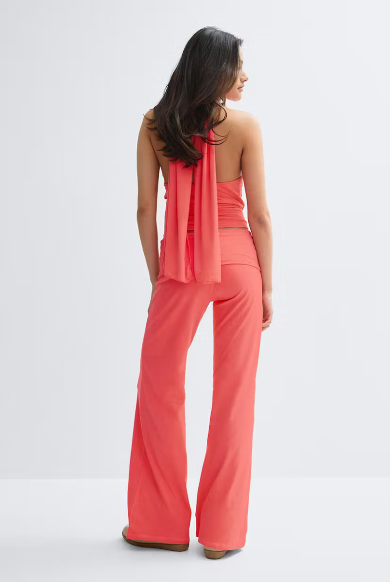 Coral fold-over waist trousers with matching top, back view on model