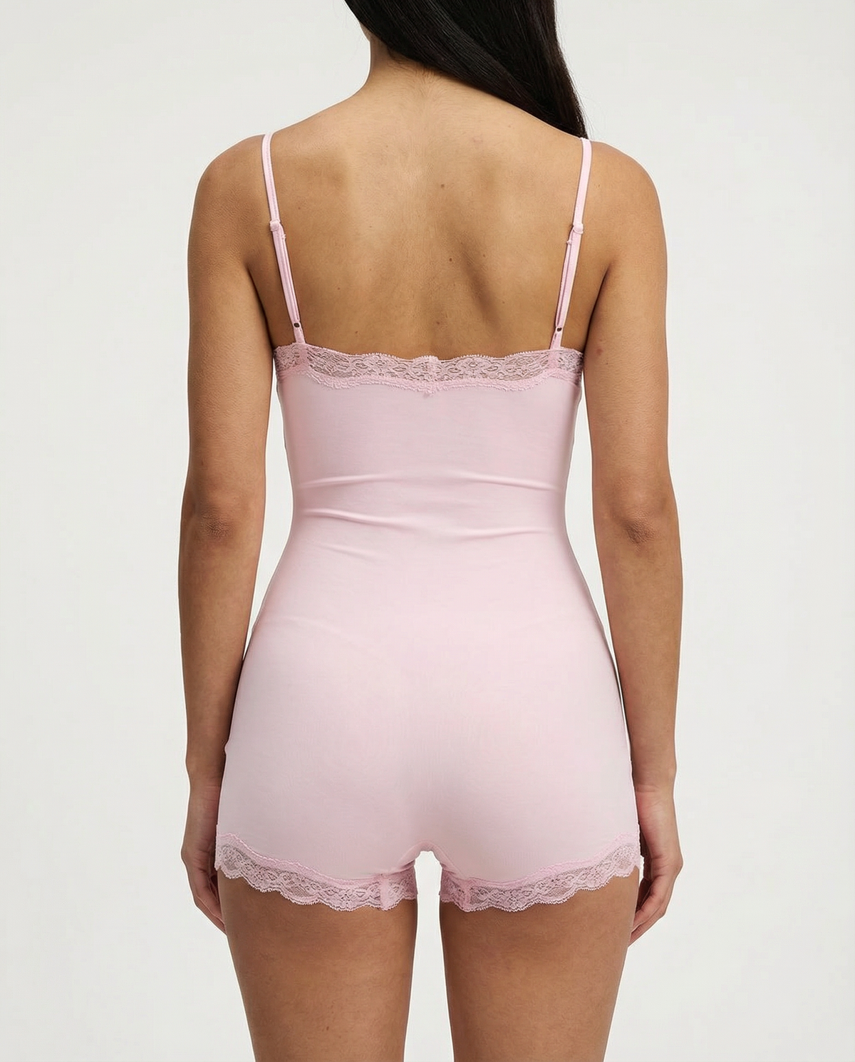 Soft pink lace-trim romper, back view on model