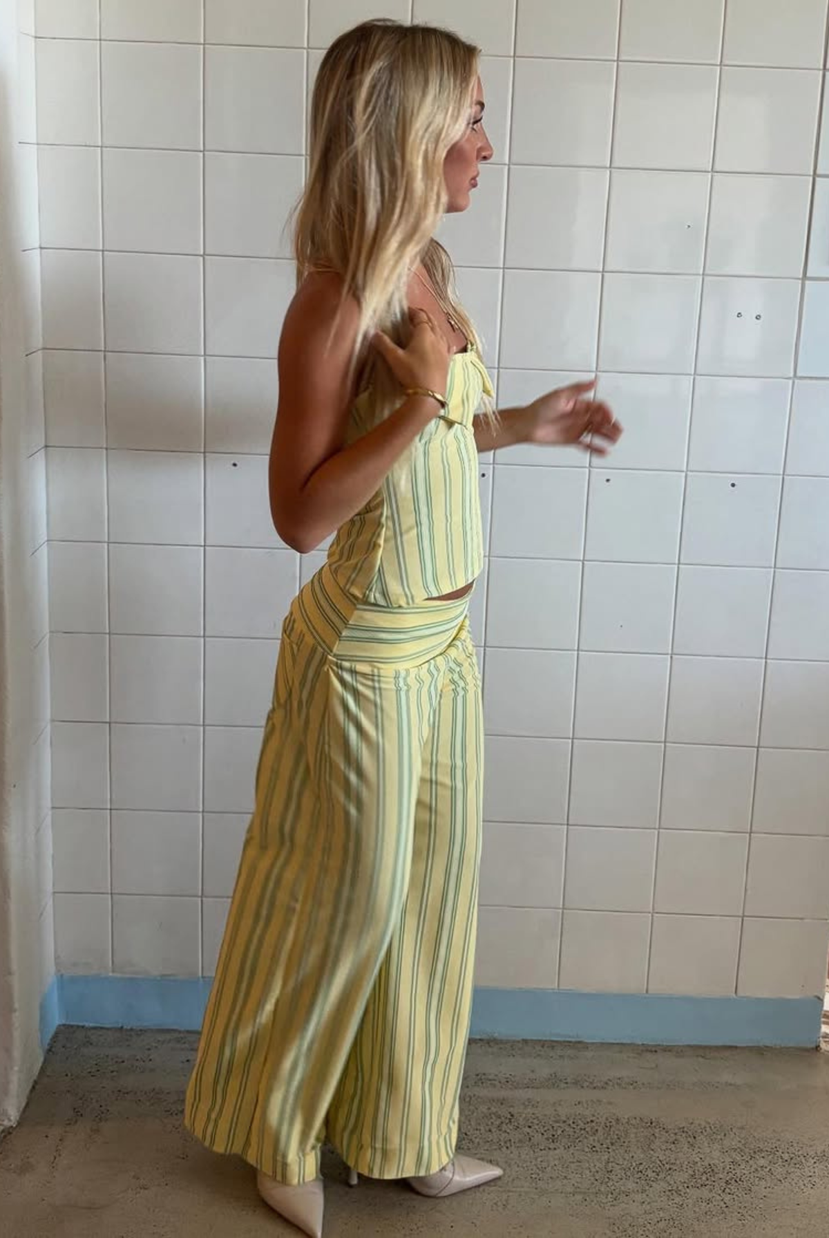 Yellow stripe top and wide-leg trousers set, side view on model