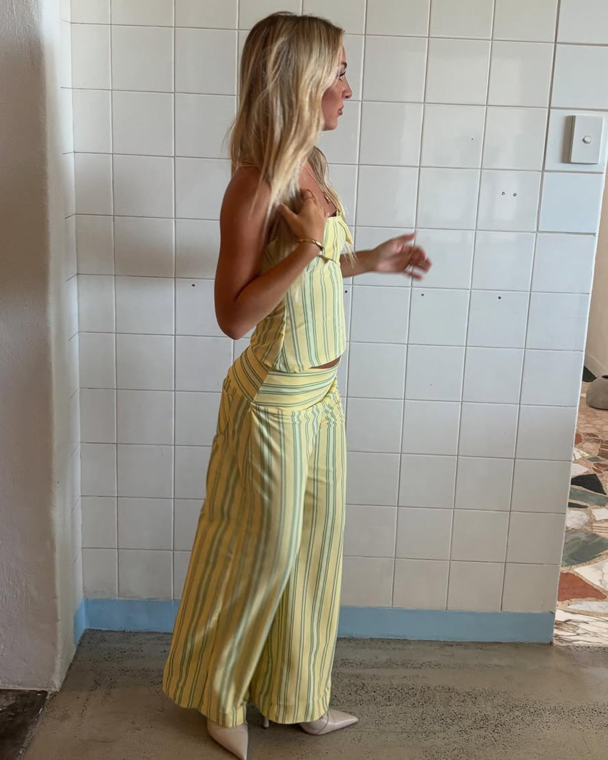 Yellow stripe top and wide-leg trousers set, side view on model