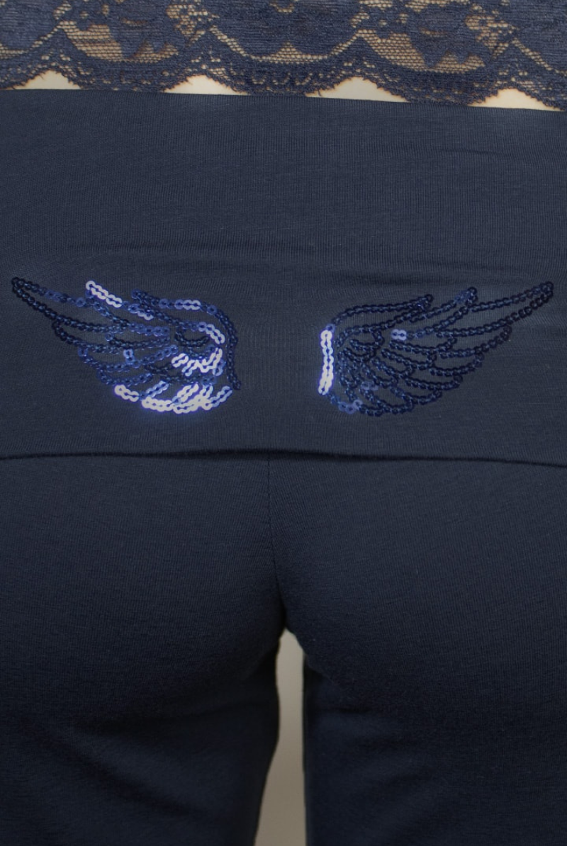 Close-up of sequin wings on navy jogger waistband