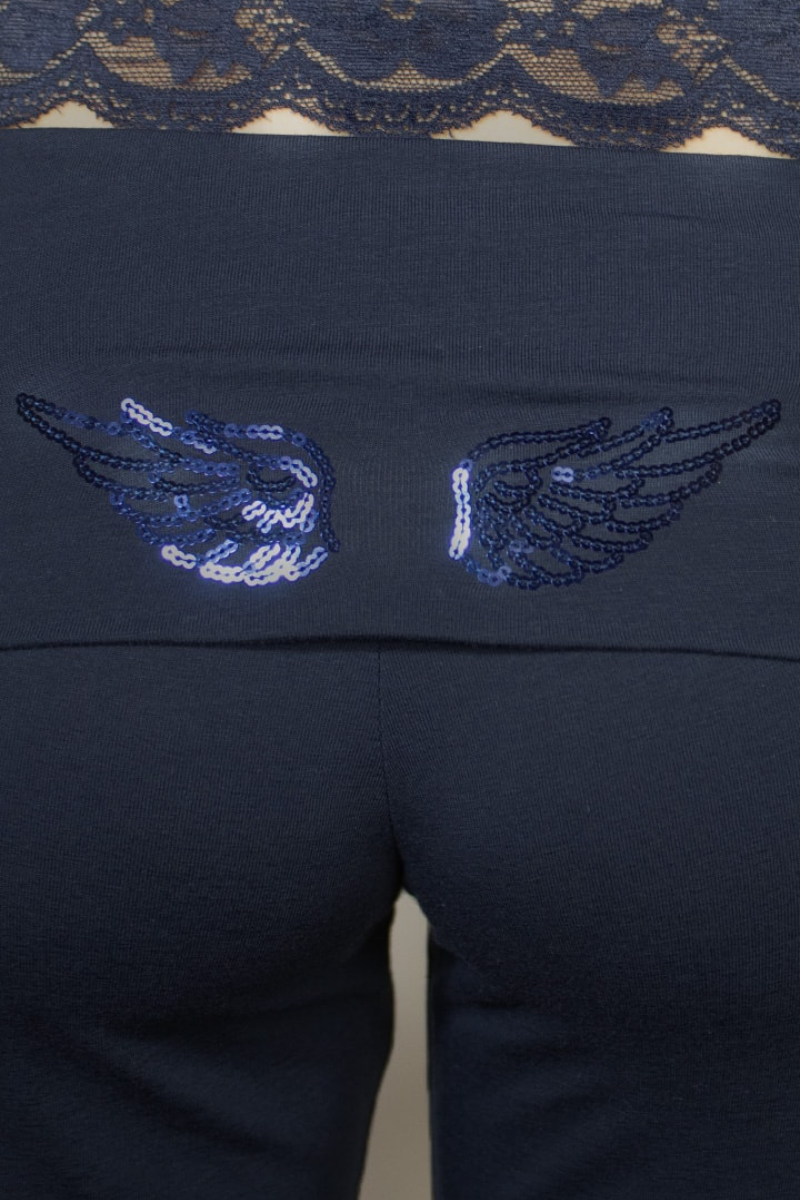 Close-up of sequin wings on navy jogger waistband