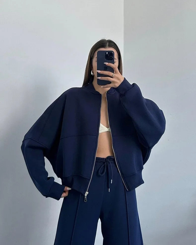 Close-up of the dark blue zip-up hoodie and joggers set on model