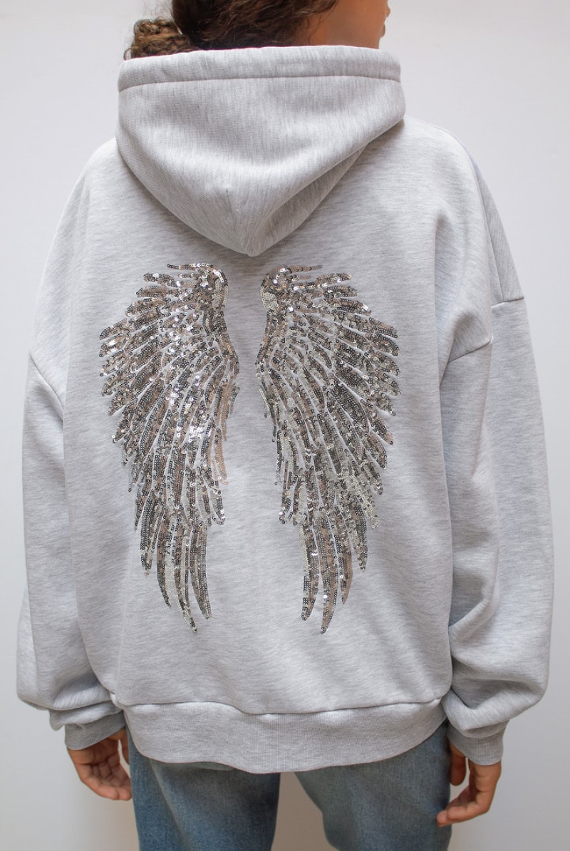 Detail of sequin angel wings on back of grey hoodie