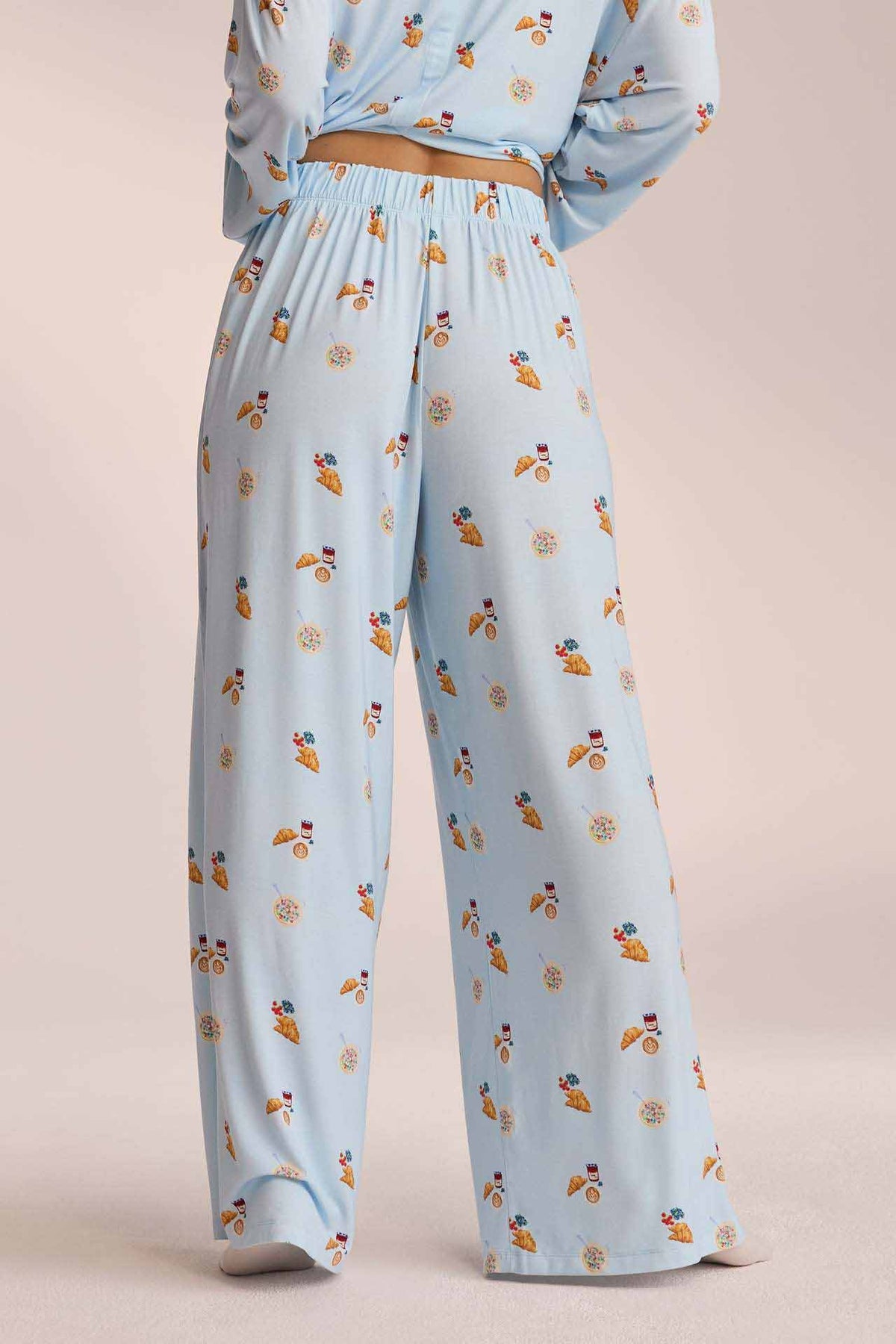 Close-up of light blue breakfast-print pyjama trousers, back view