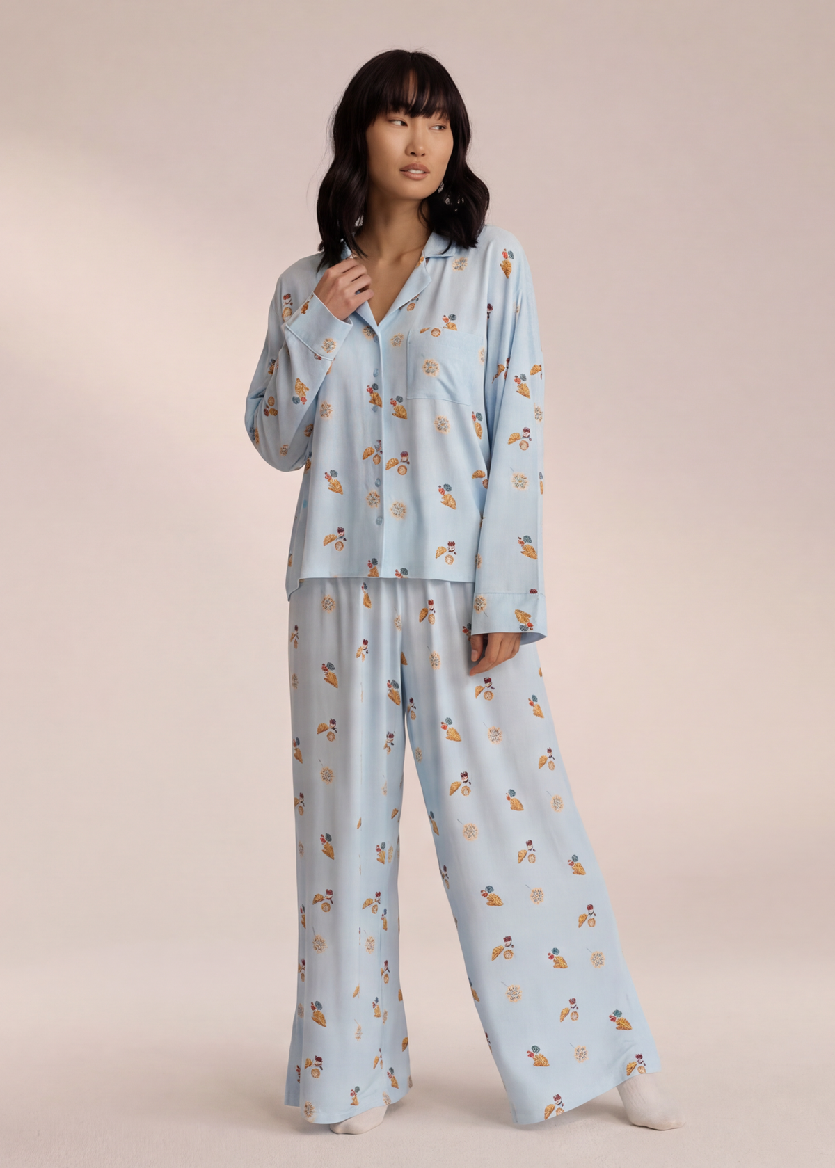 Light blue breakfast-print pyjama set with trousers, angled view