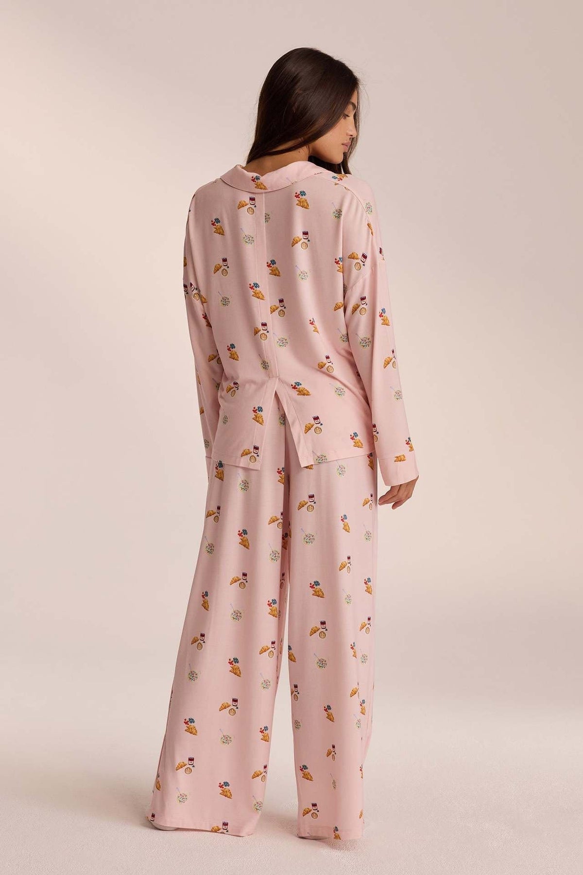 Pink breakfast-print pyjama set with trousers, back view on model