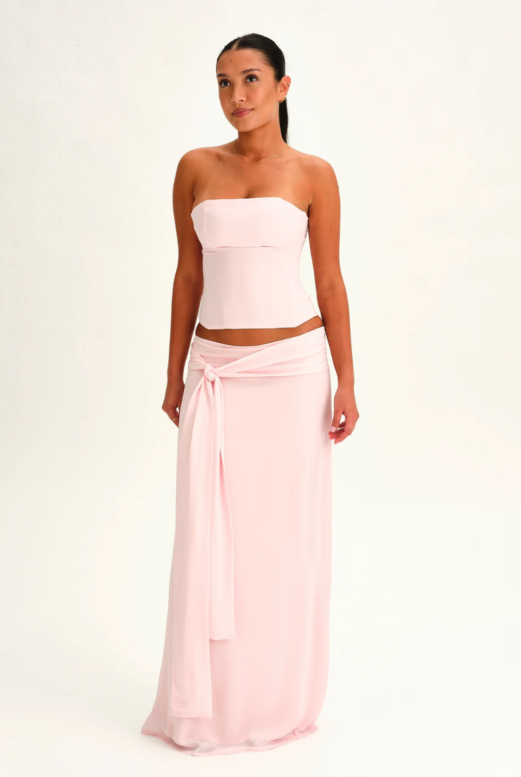 Blush pink corset top and wrap maxi skirt, front view on model
