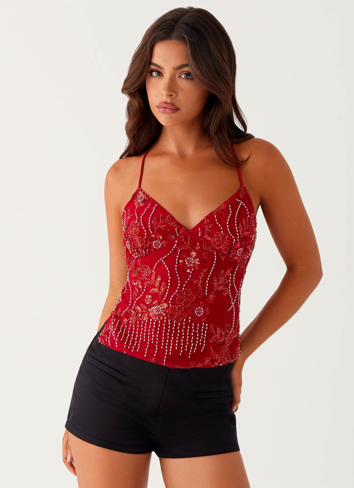 Red sequin floral cami top, front view on model