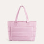 Pink quilted puffer tote bag, front view on plain background