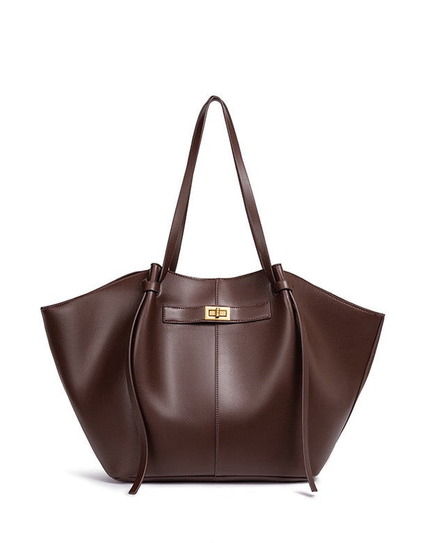 Chocolate brown leather tote bag with twist-lock strap detail, front view