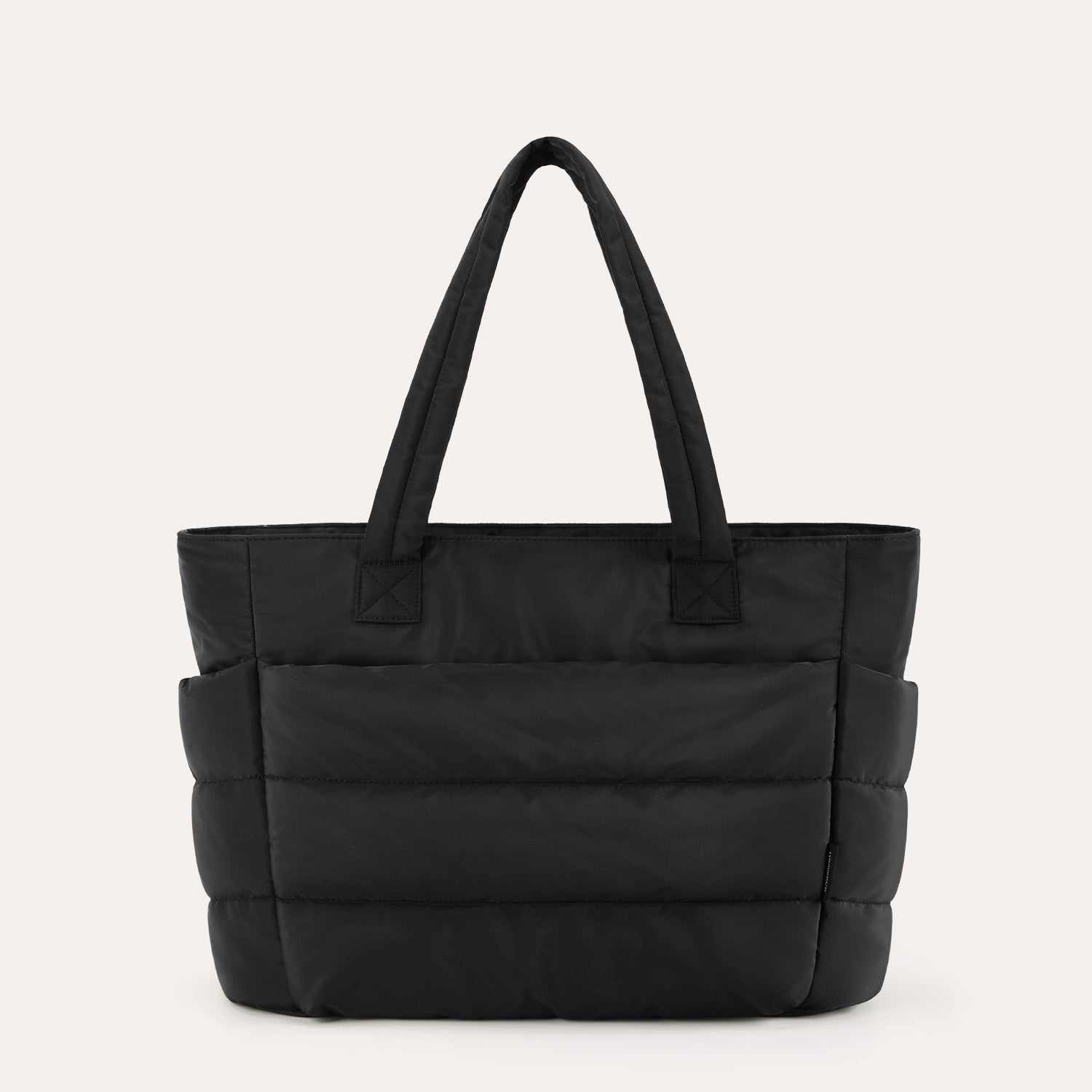Black quilted puffer tote bag, front view on plain background