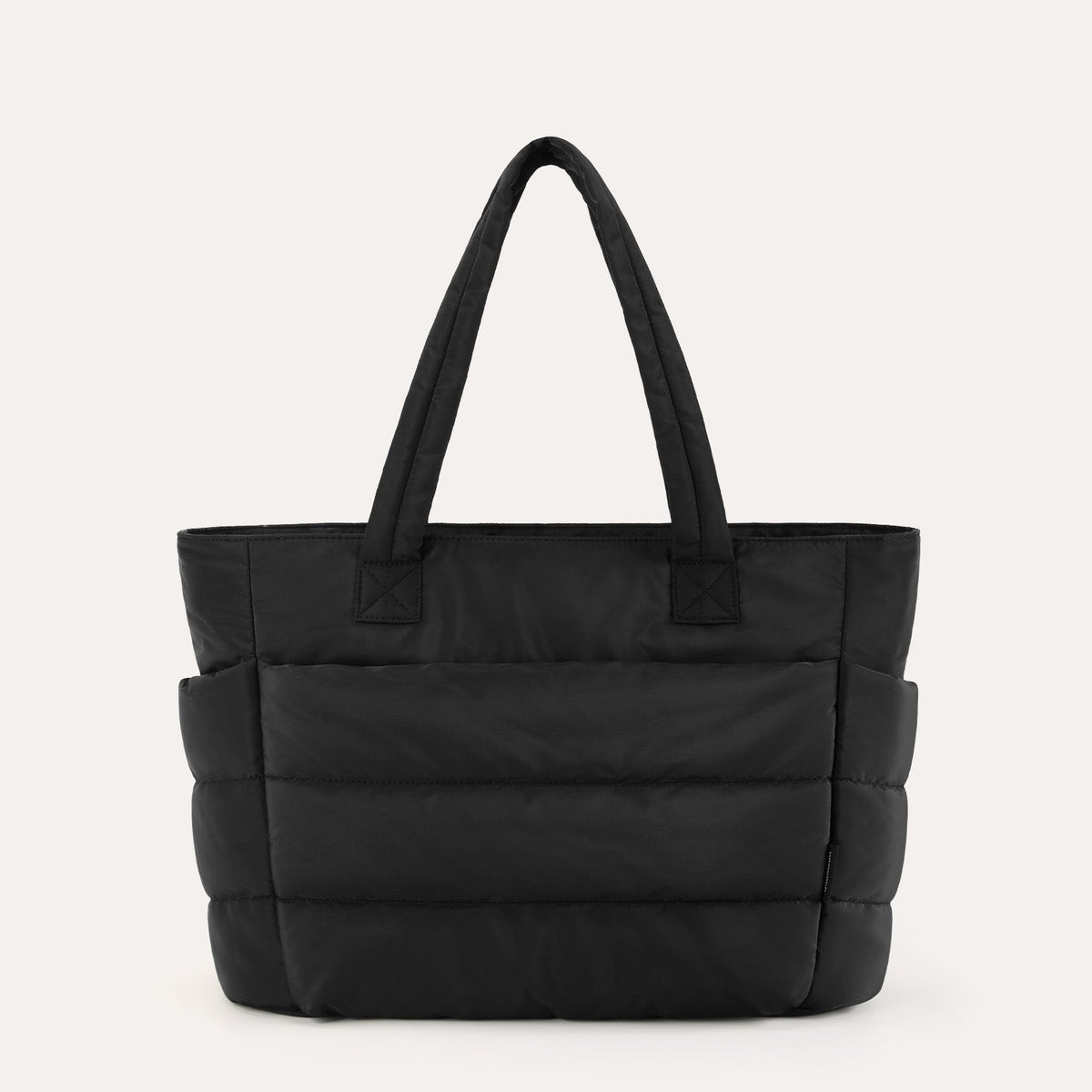 Black quilted puffer tote bag, front view on plain background