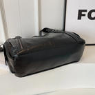 Midnight black leather shoulder bag, base and side seam view