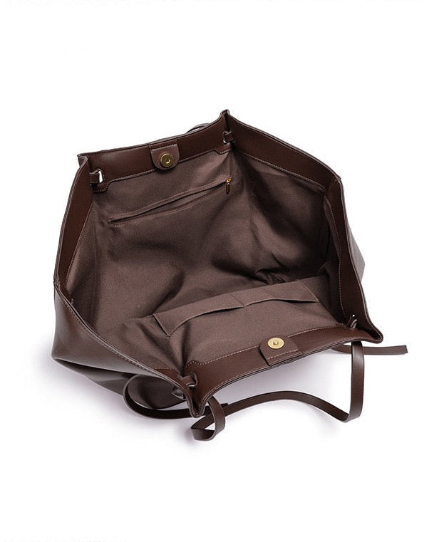 Chocolate brown leather tote bag open showing inner pockets, top-down view