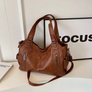 Cognac tan leather shoulder bag with zip pockets, front view