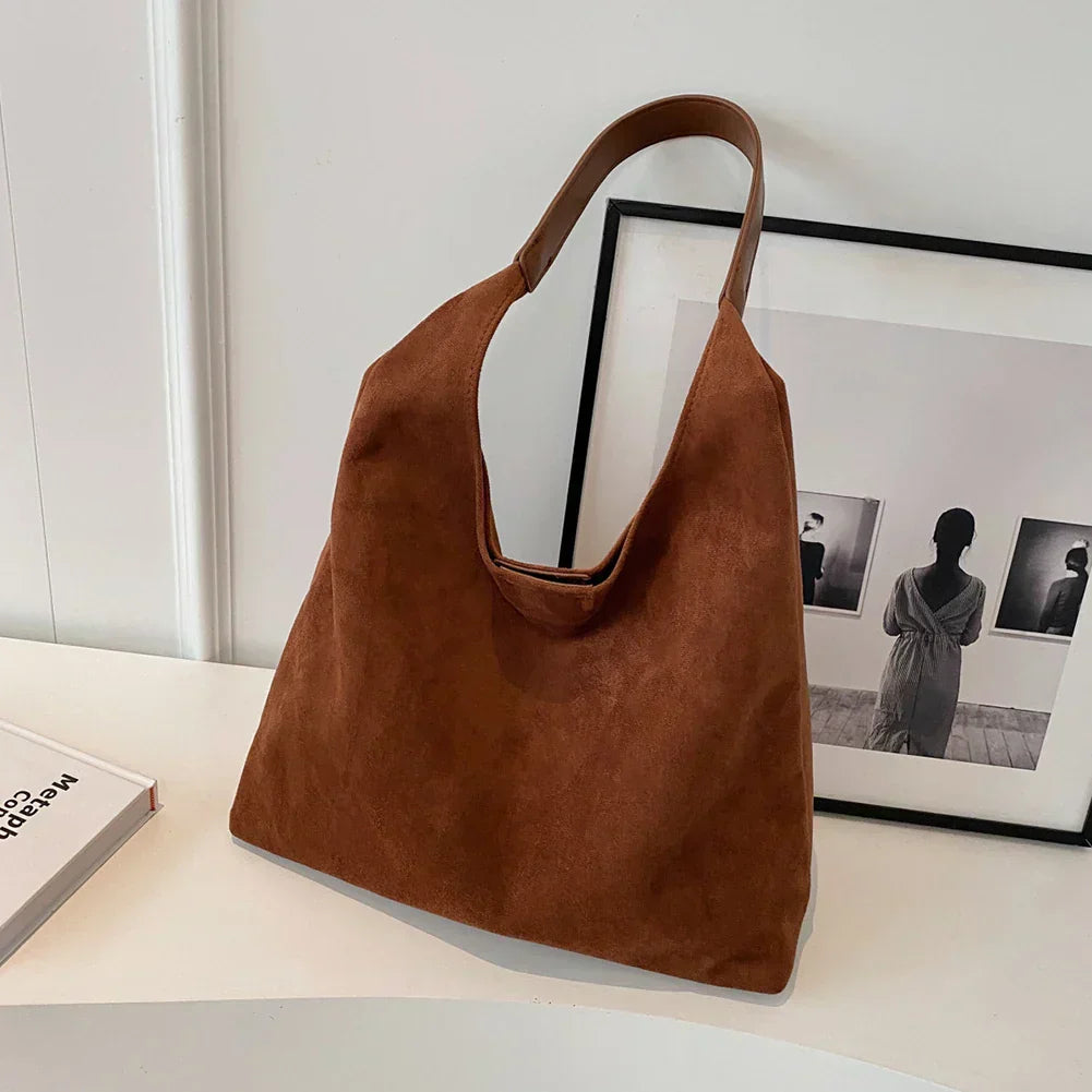 Coffee brown suede shoulder tote bag on a desk