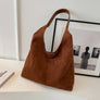 Coffee brown suede shoulder tote bag on a desk