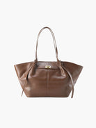Coffee brown leather tote bag with twist-lock strap detail, front view