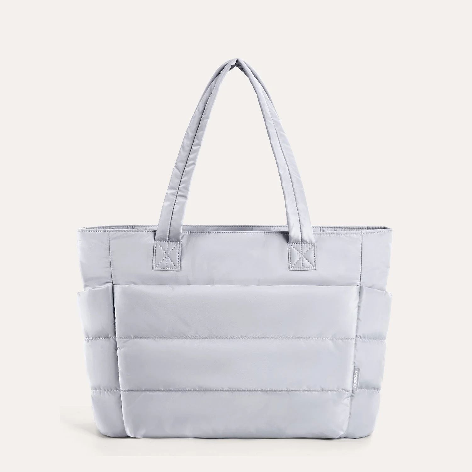 Light grey quilted puffer tote bag, front view on plain background