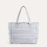 Light grey quilted puffer tote bag, front view on plain background